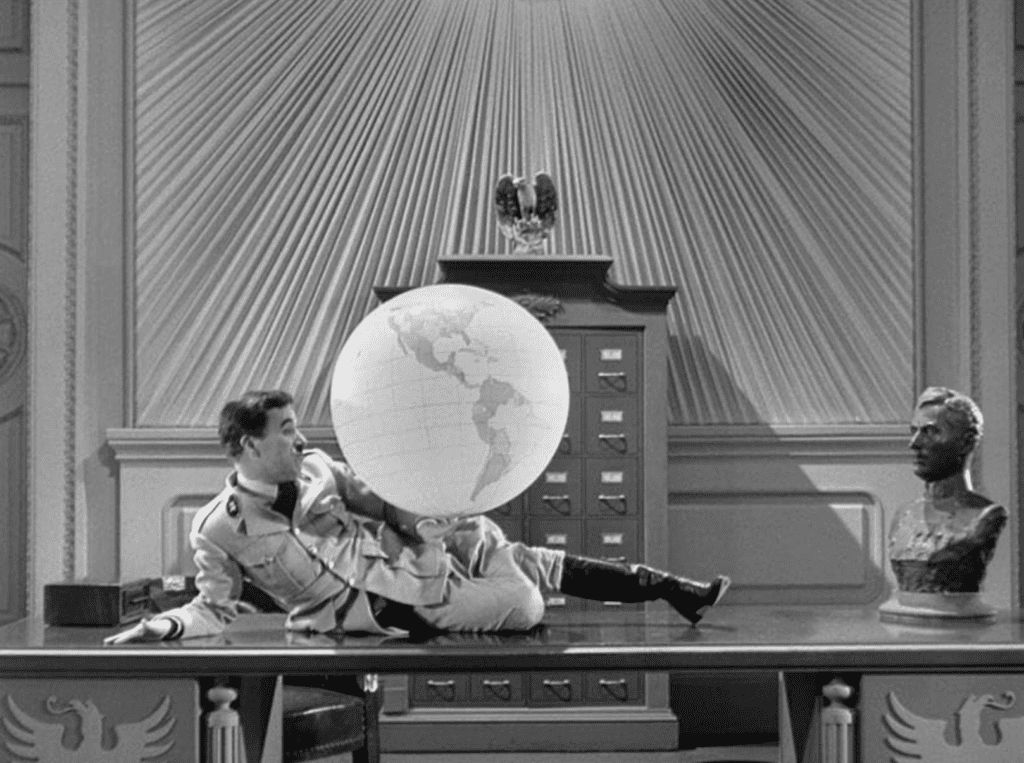 Charlie Chaplin's Adenoid Hynkel toys with an inflatable globe in The Great Dictator (1940).